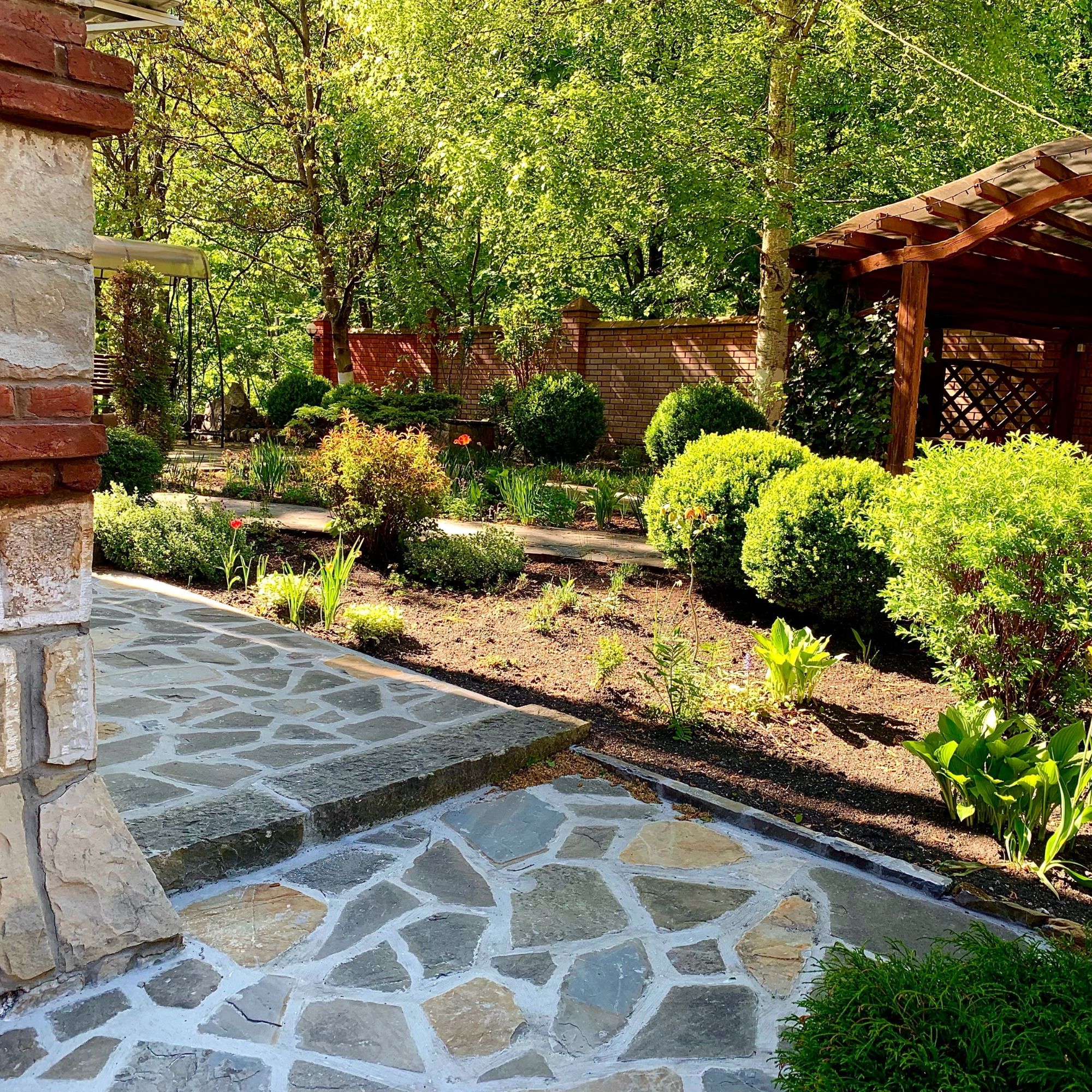 Flagstone walkway and planting beds installed by Topo d'Oro Landscape Design