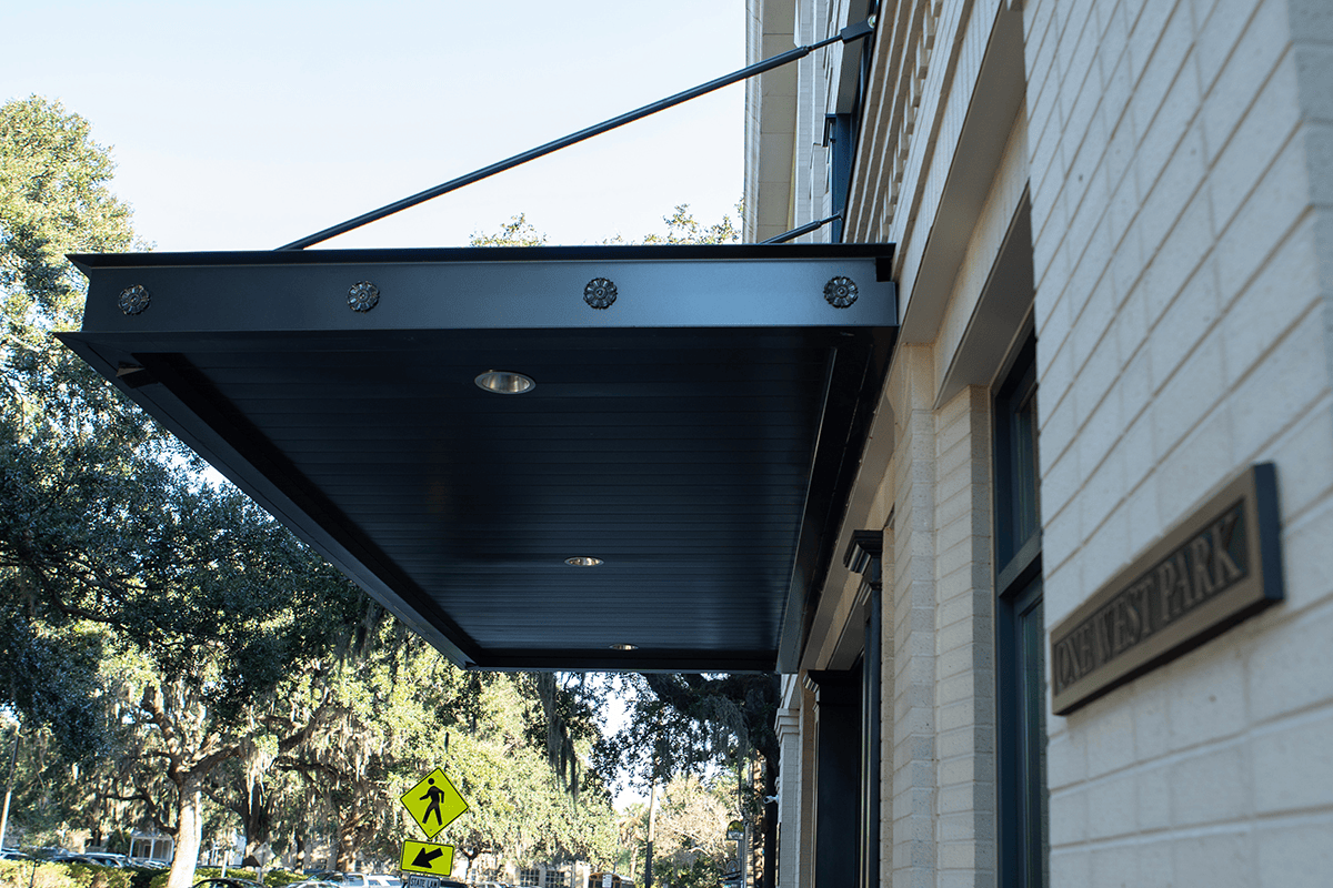 Custom steel and aluminum entrance awning fabricated and installed by Topo d'Oro Landscape Design