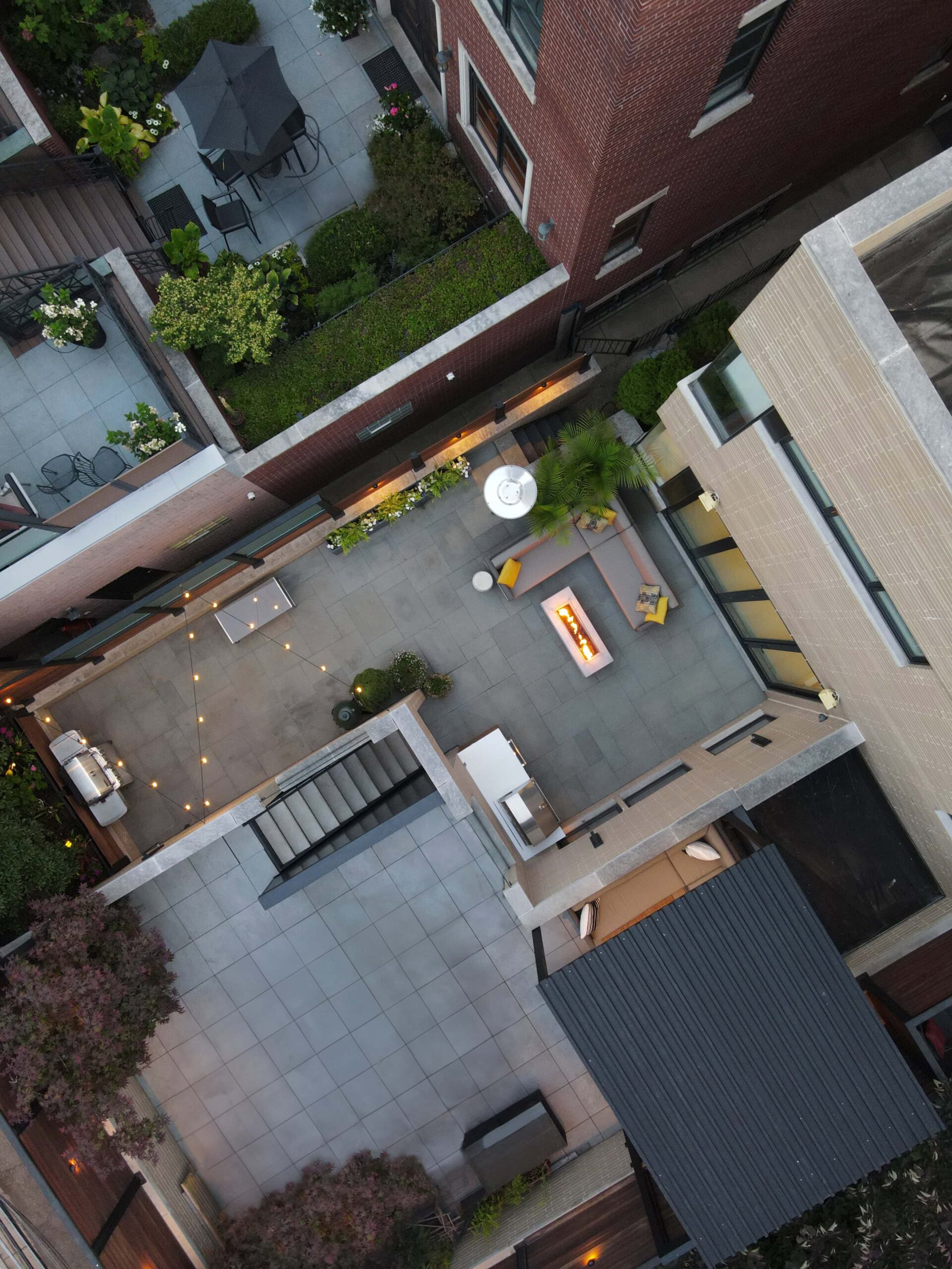 Aerial view of a paved terrace built by Topo d'Oro Landscape Design